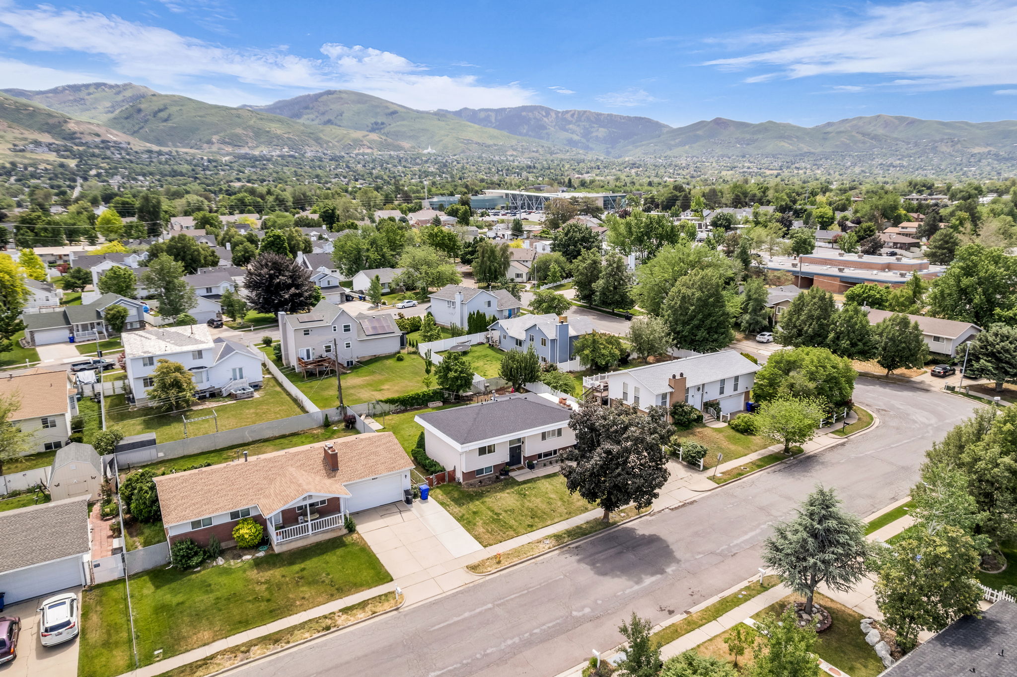 Established neighborhood featuring mature trees and mountain backdrops