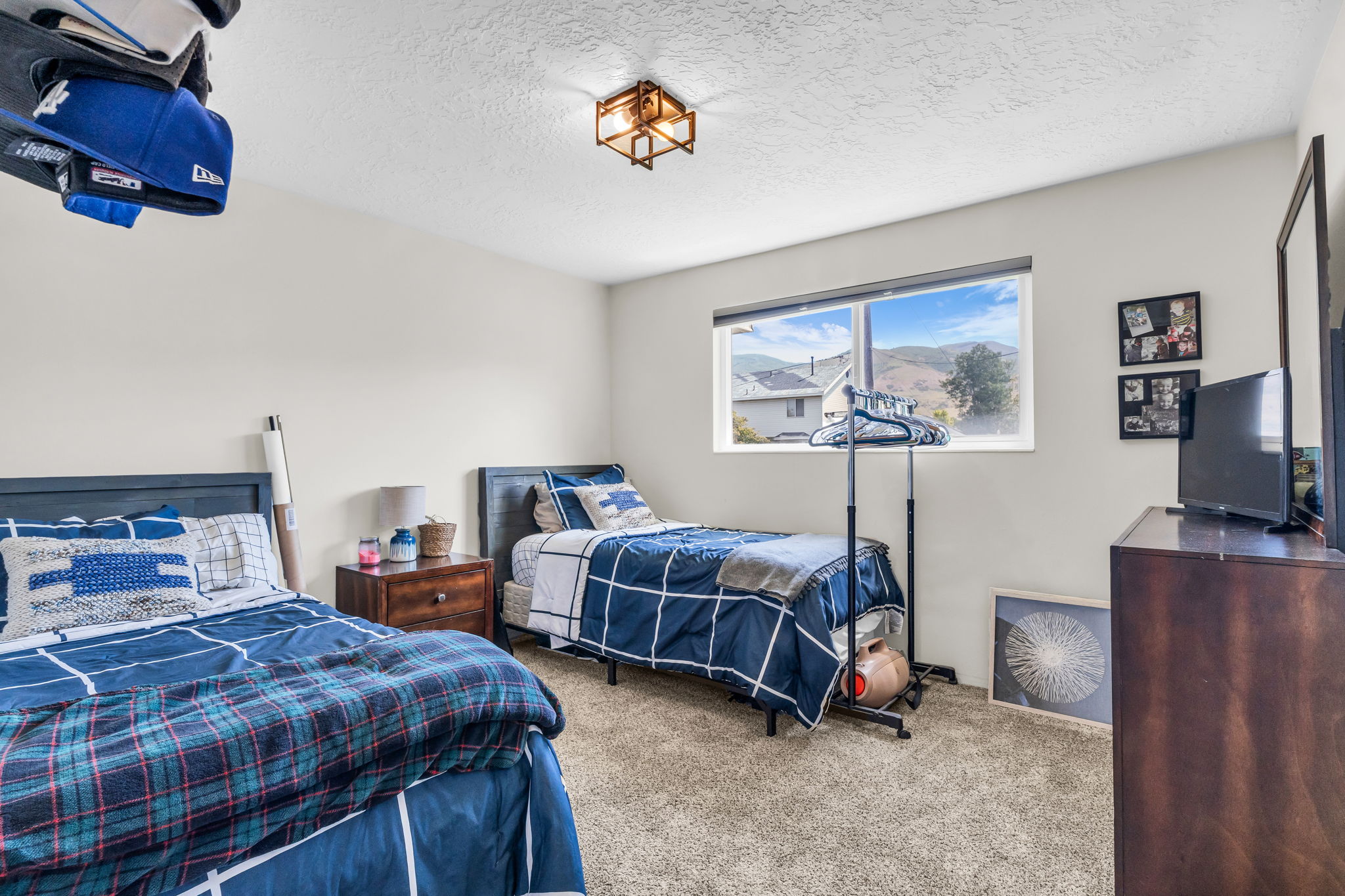 Spacious room featuring neutral-toned walls and plush carpet flooring