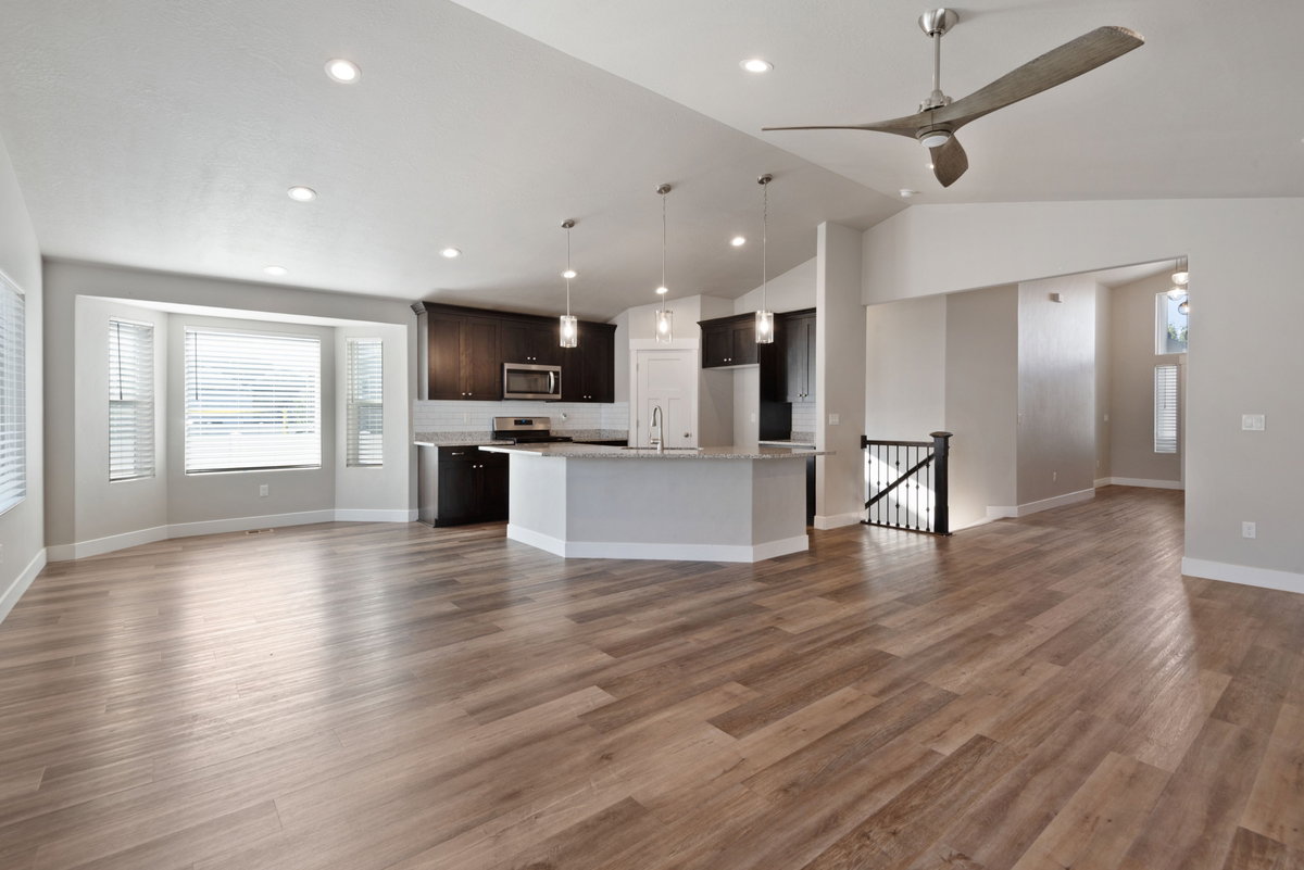 Open-concept living space featuring wood-finish flooring, recessed lighting, and a modern ceiling fan