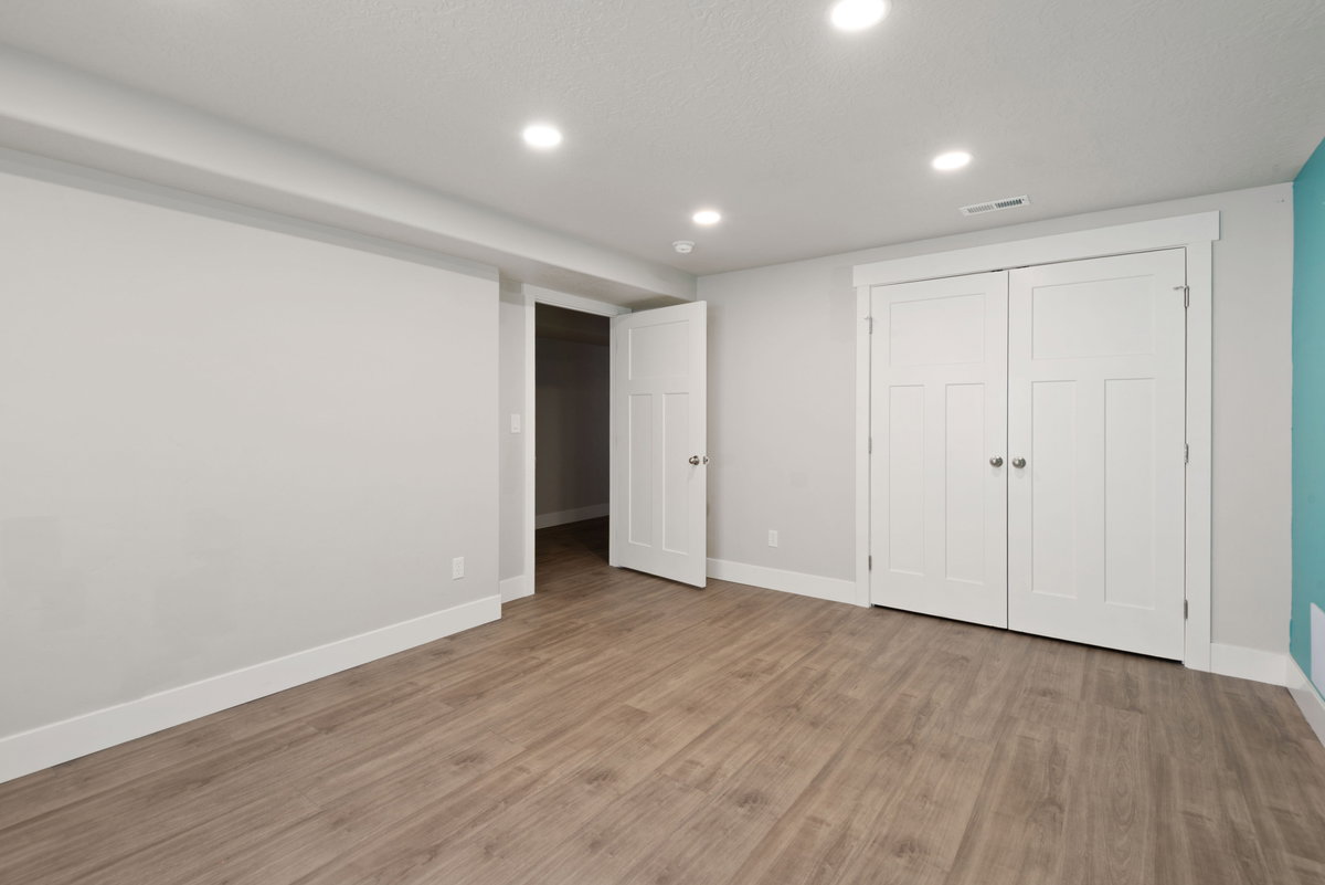 Room featuring wood-finish flooring, recessed lighting, and a white bi-fold closet