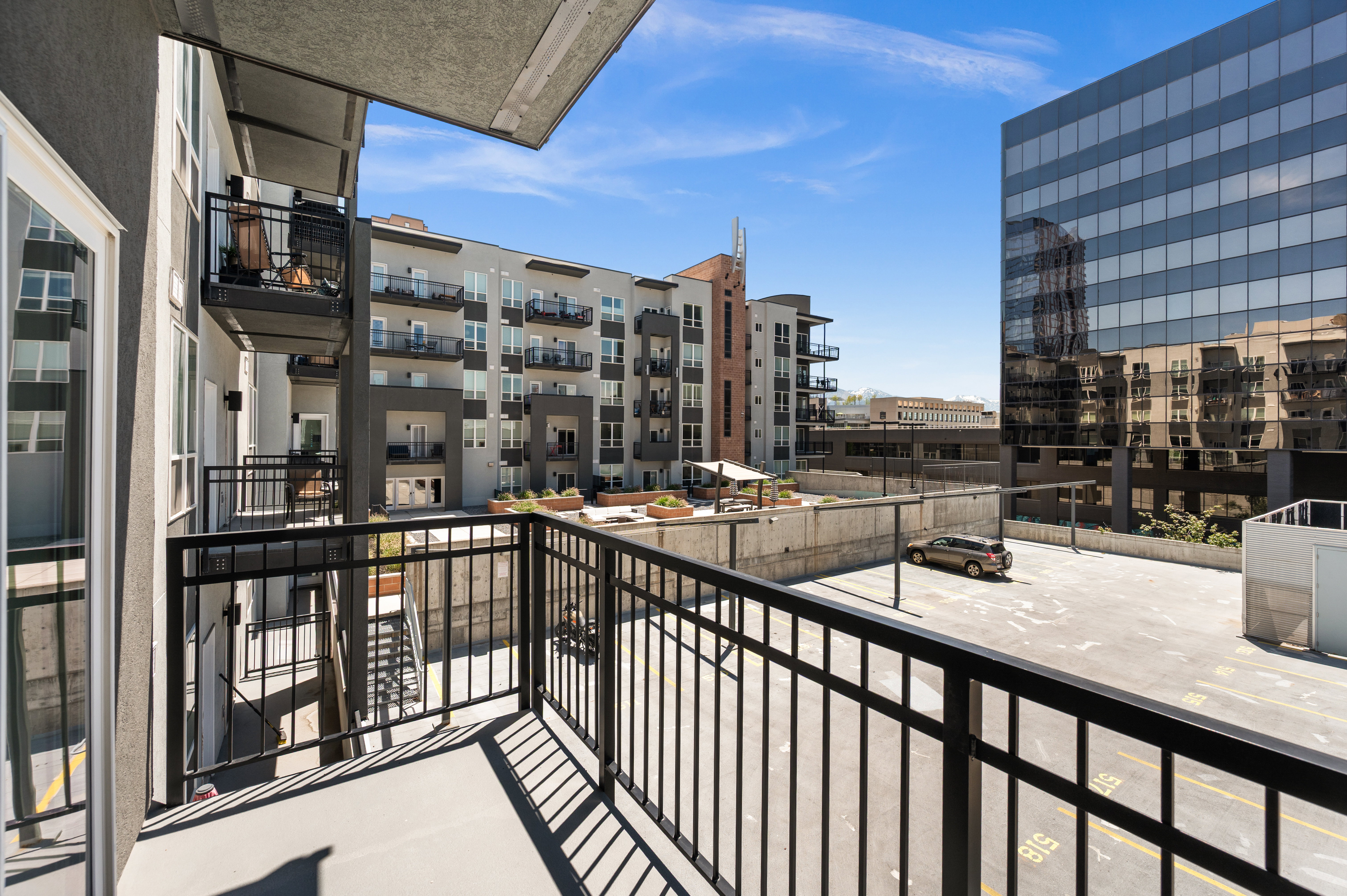 Private outdoor balcony with black metal railings