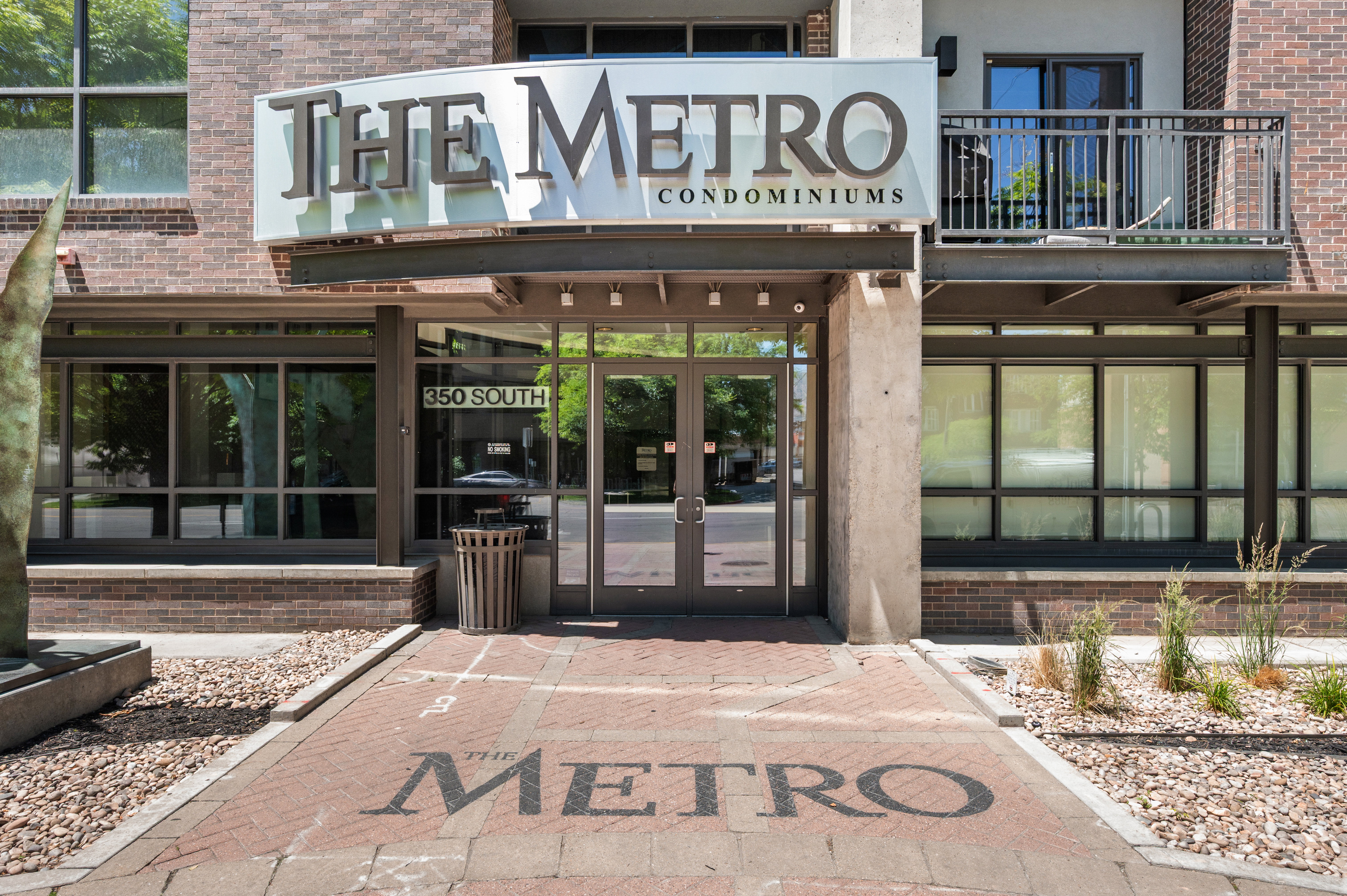 Brick facade building with a prominent "The Metro Condominiums" sign