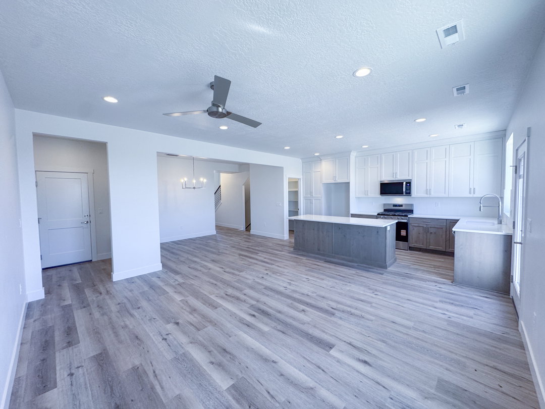 Open-concept living space with wood-finish flooring