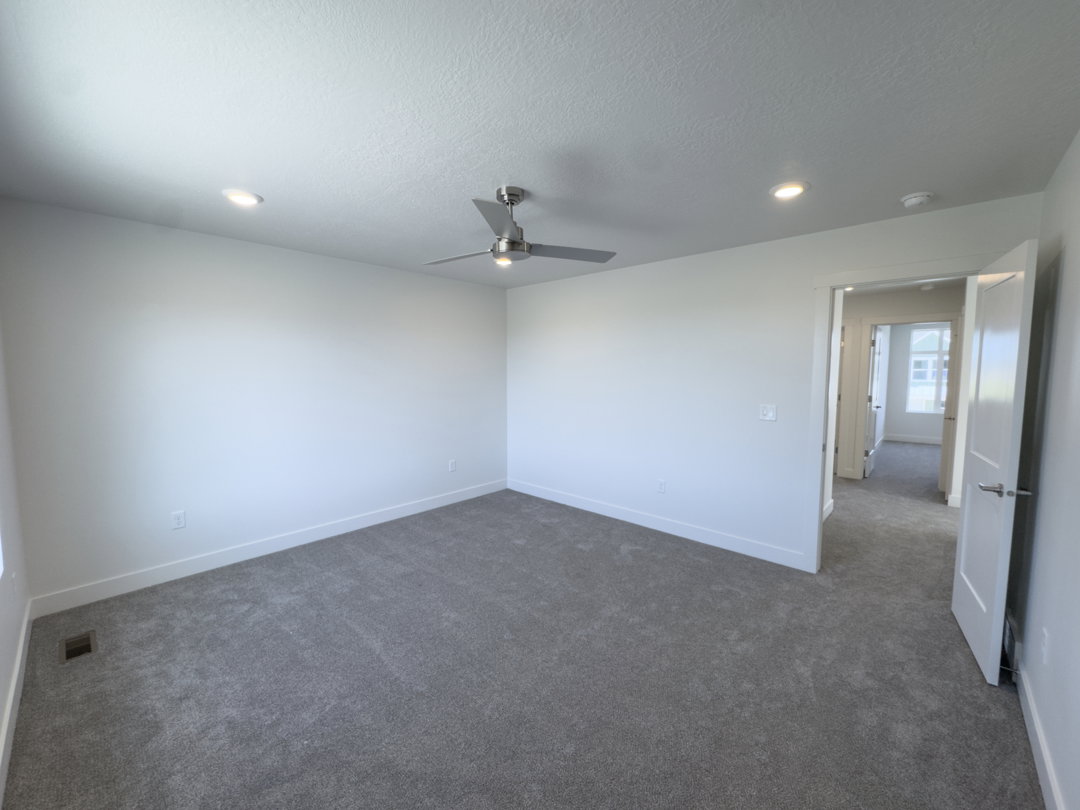 Bright room featuring neutral-toned carpet and white walls
