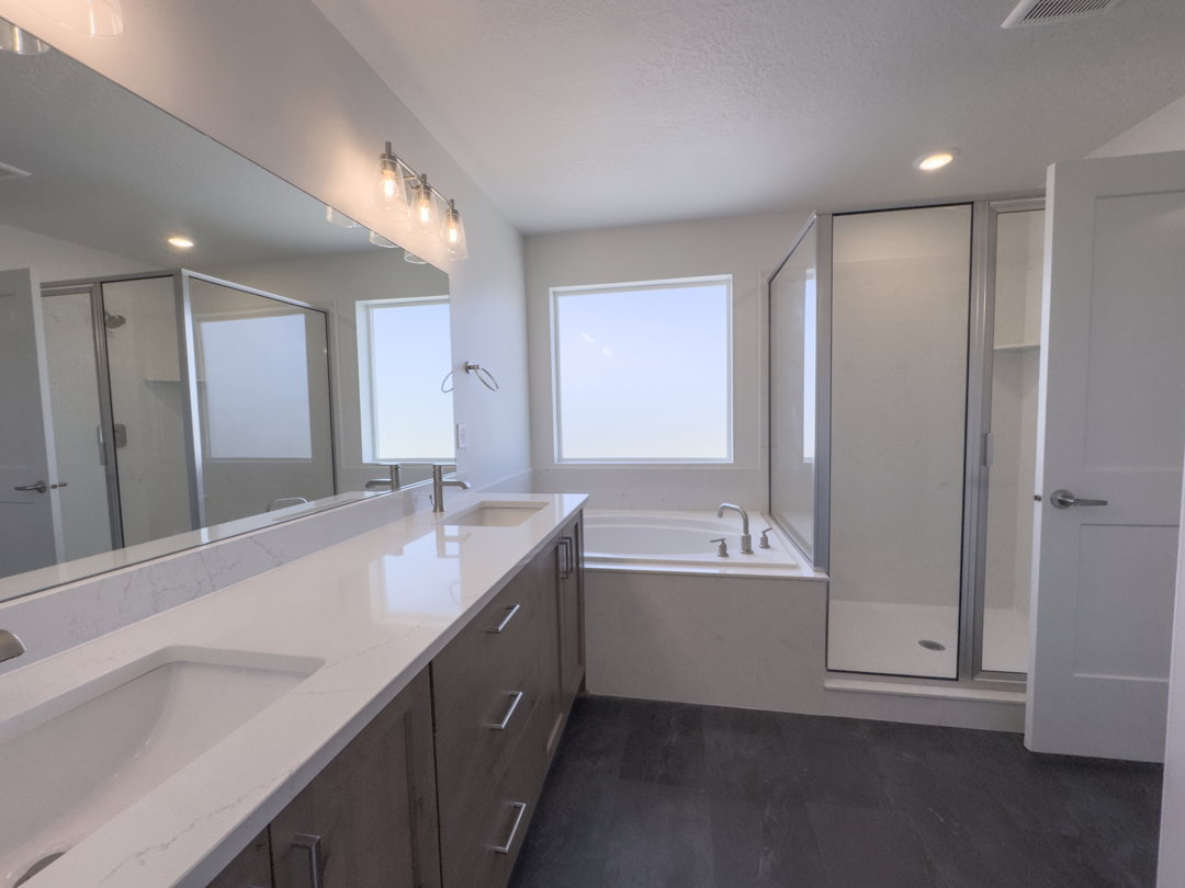Dual vanity with white undermount sinks and light-toned countertops