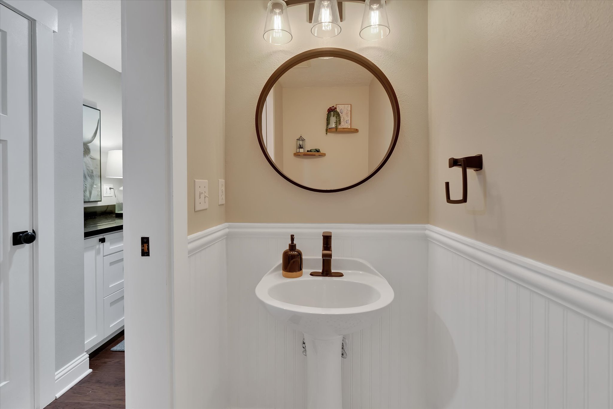 Pedestal sink with bronze faucet