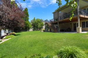 Spacious lawn area with mature trees and landscaping