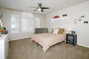 Bedroom featuring neutral wall tones and plush carpet flooring