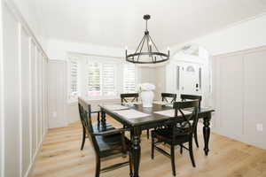Dining area featuring light wood-finish flooring and board and batten wall detailing