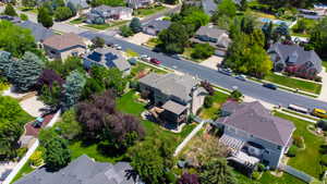 Residential neighborhood featuring mature landscaping, paved streets with sidewalks, and a variety of home styles