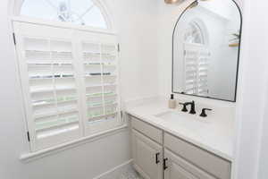 Arched window with plantation shutters