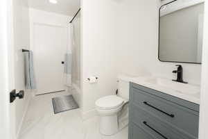 Bathroom featuring a vanity with a gray cabinet, white countertop, and rectangular undermount sink