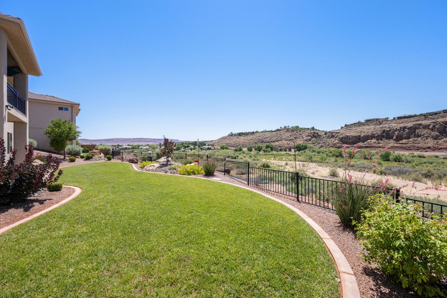 Expansive terraced yard with a manicured lawn and decorative rock landscaping