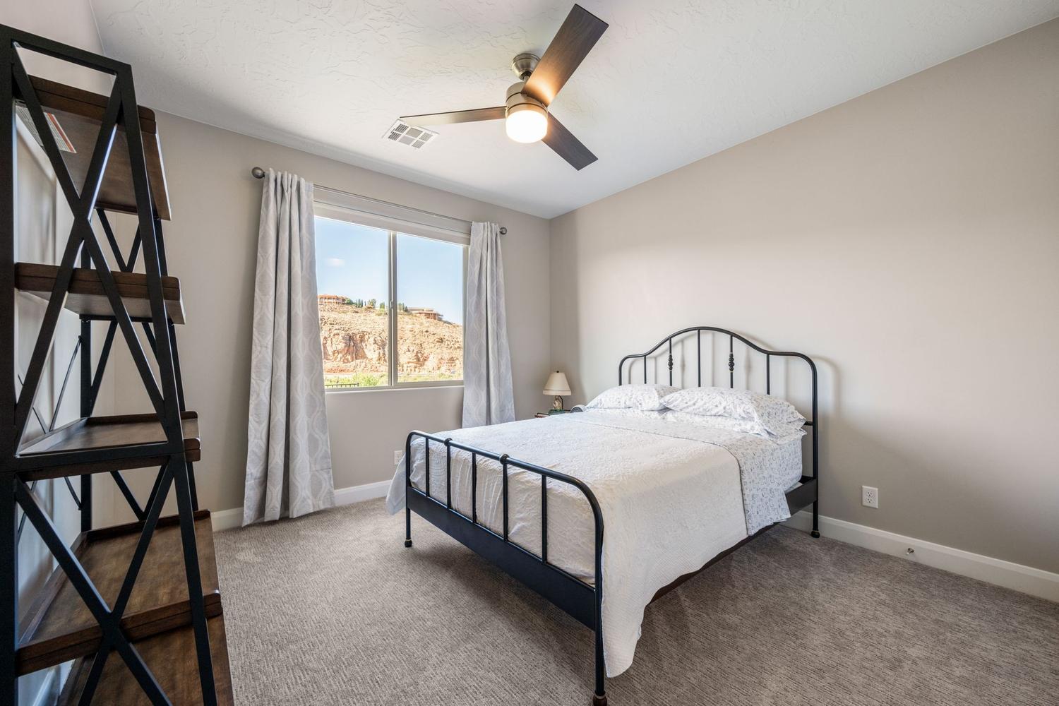 Bedroom with neutral-toned walls and carpet flooring