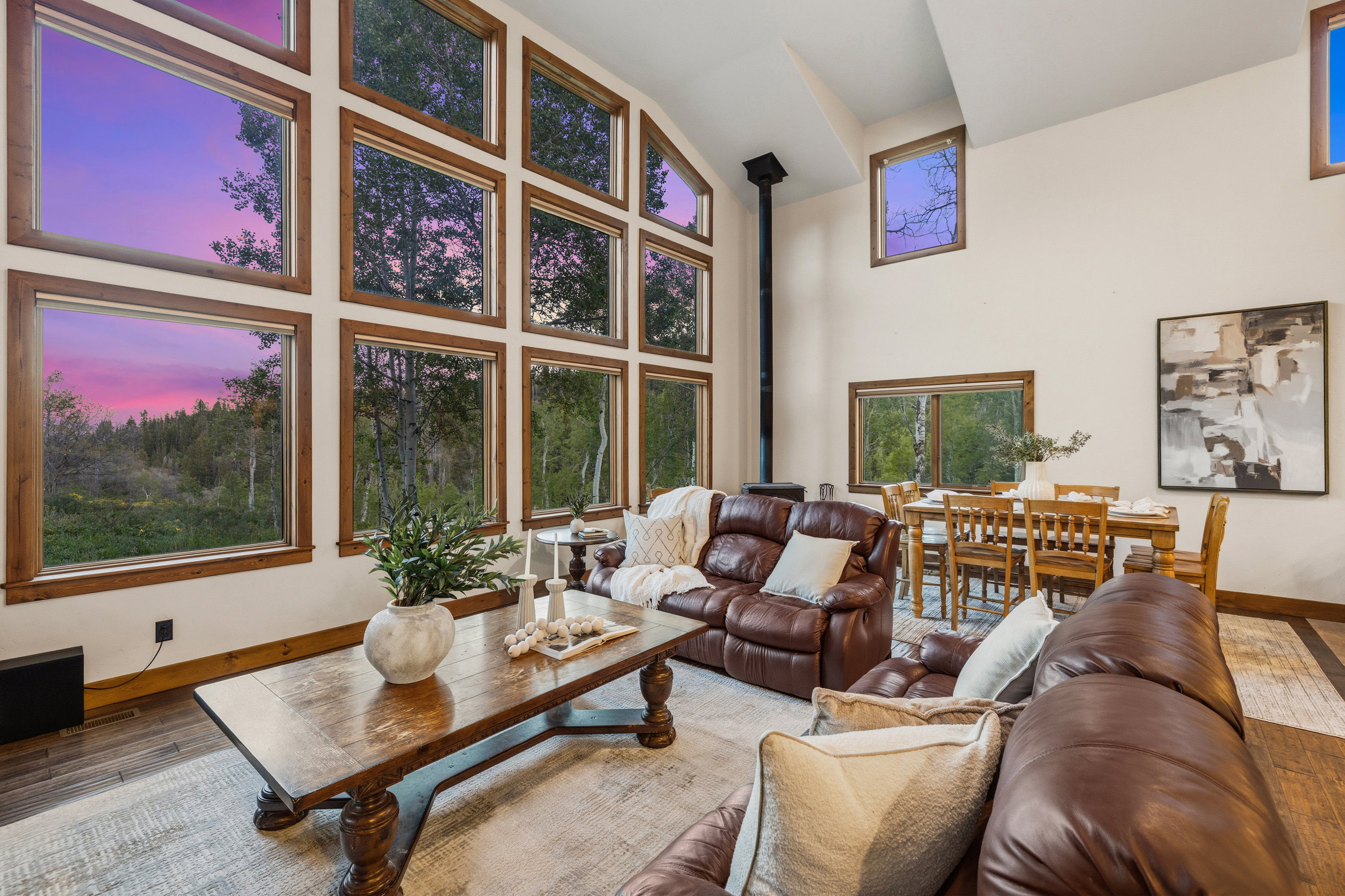 Vaulted ceilings featuring expansive window arrays with wood trim