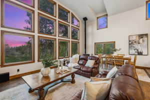 Vaulted ceilings featuring expansive window arrays with wood trim