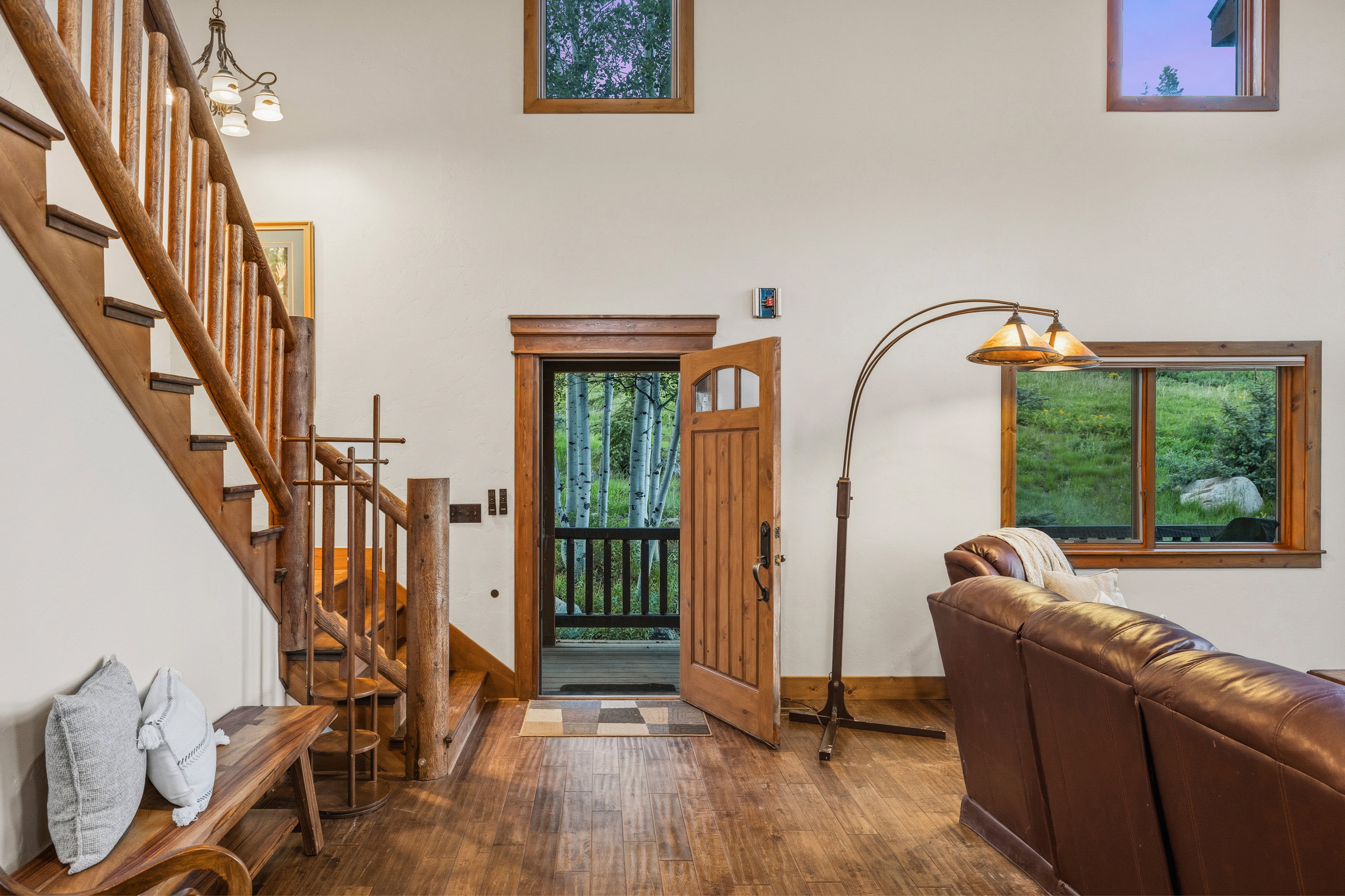 Wood-finish flooring throughout, complemented by a rustic wood staircase and balusters