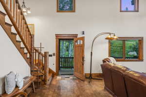 Wood-finish flooring throughout, complemented by a rustic wood staircase and balusters