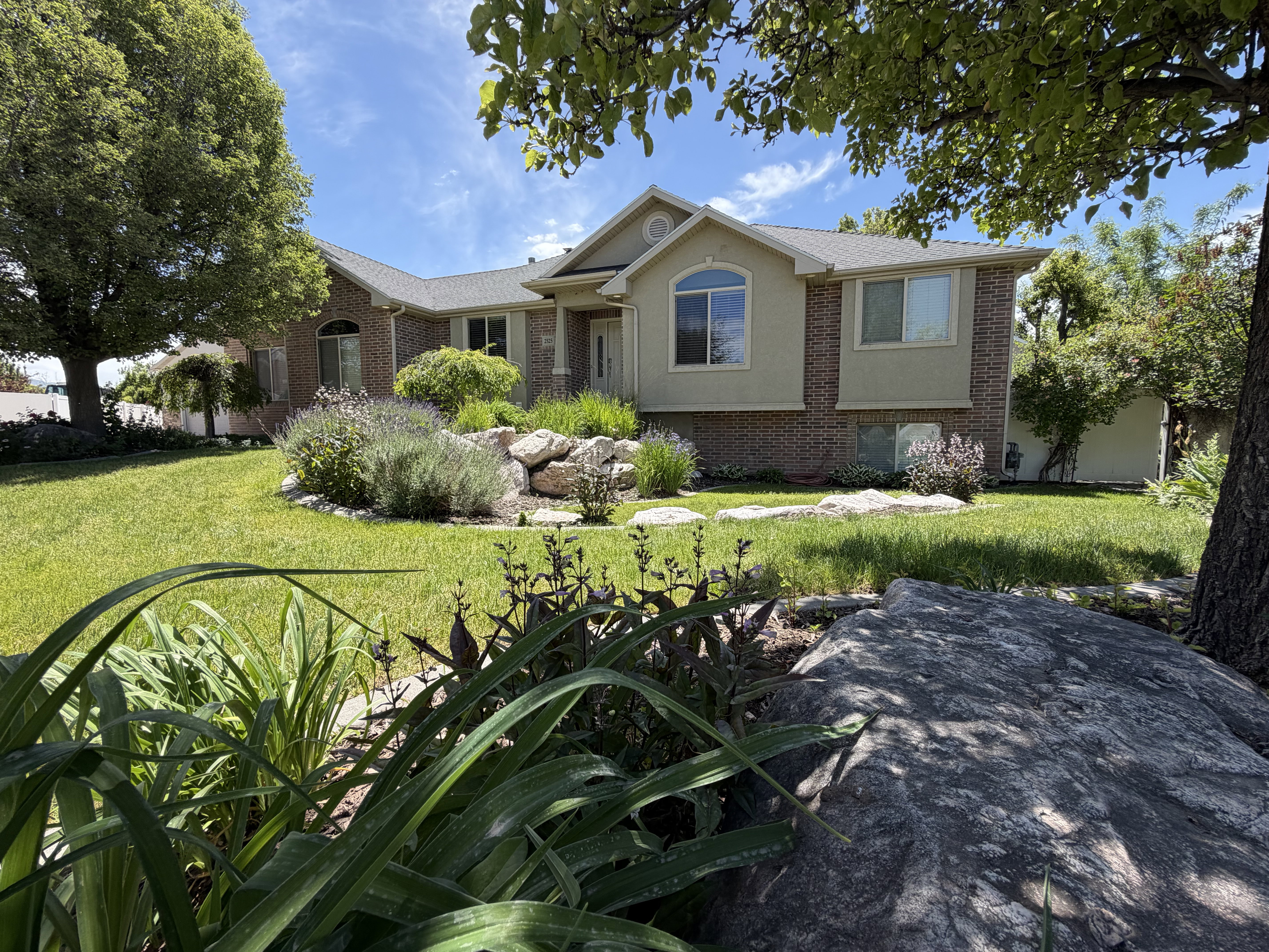 Brick and stucco exterior with multiple window styles