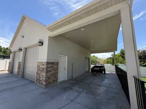 Two-car garage with overhead doors and stone veneer siding