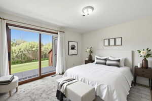 VIRTUAL  RENDERING:Spacious sleeping area featuring a wide glass sliding door, a private deck, light-toned walls, and a contemporary ceiling fixture