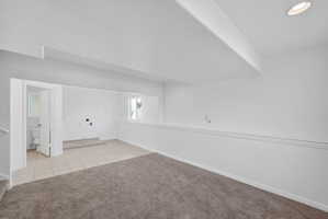 Lower level room featuring recessed lighting and a neutral color palette