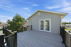 Expansive upper-level deck featuring composite decking and black metal railings