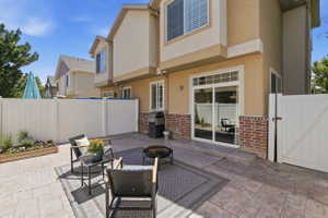 Private outdoor patio space featuring stamped concrete flooring