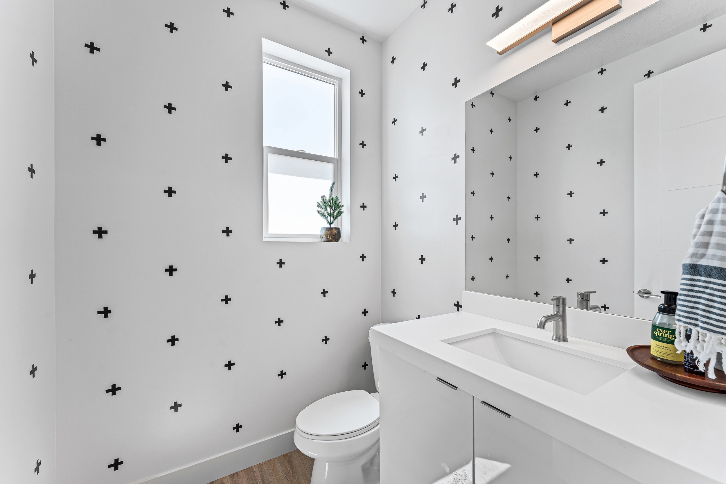 Contemporary vanity with an integrated rectangular sink, brushed nickel faucet, and under-cabinet storage