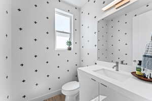 Contemporary vanity with an integrated rectangular sink, brushed nickel faucet, and under-cabinet storage