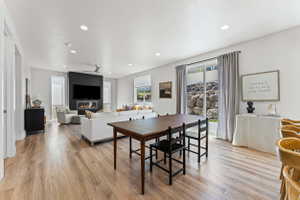 Open-concept living space featuring wood-finish flooring, recessed lighting, and a modern ceiling fan