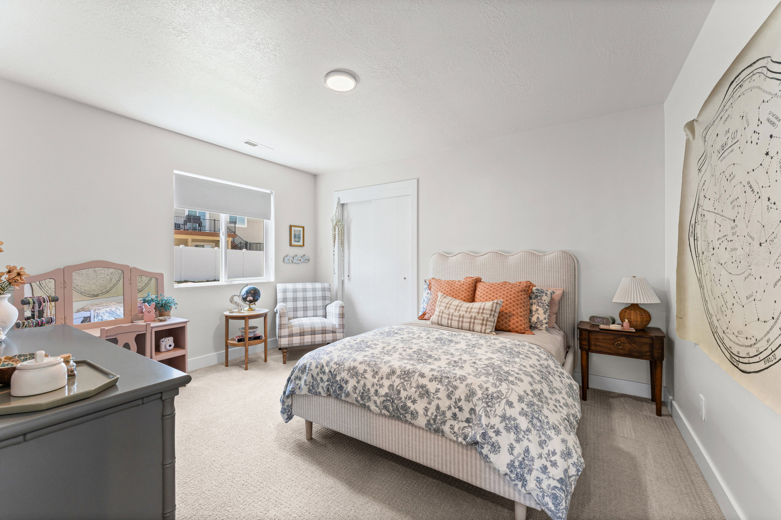 Spacious room featuring neutral carpeting, recessed lighting, and a window with blinds