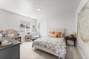 Spacious room featuring neutral carpeting, recessed lighting, and a window with blinds