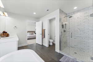 Walk-in shower with clear glass enclosure and white subway tile surround, featuring a rainfall showerhead