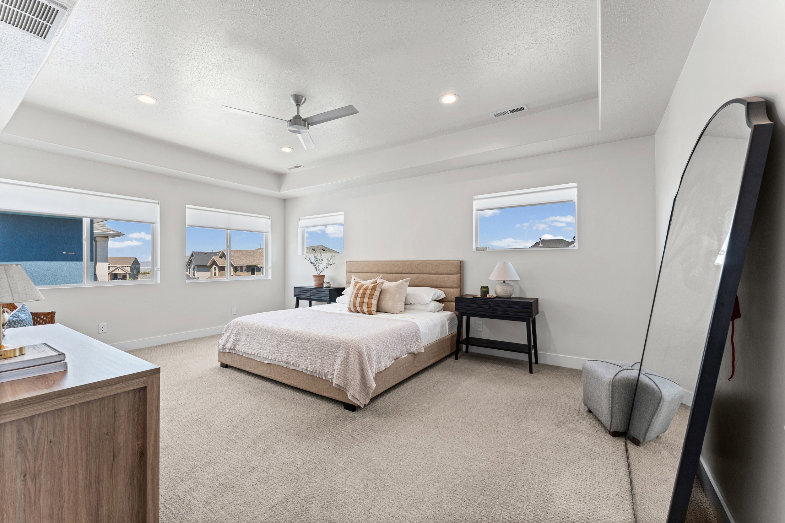 Spacious room featuring multiple windows, recessed lighting, and a ceiling fan