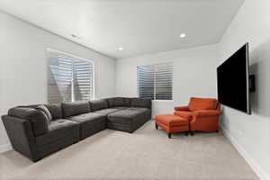 Carpeted room with white walls, recessed lighting, and two windows