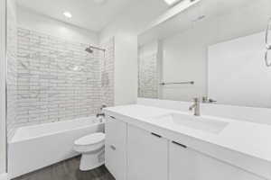 Modern bathroom featuring a vanity with an integrated sink, brushed nickel faucet, and full-width mirror