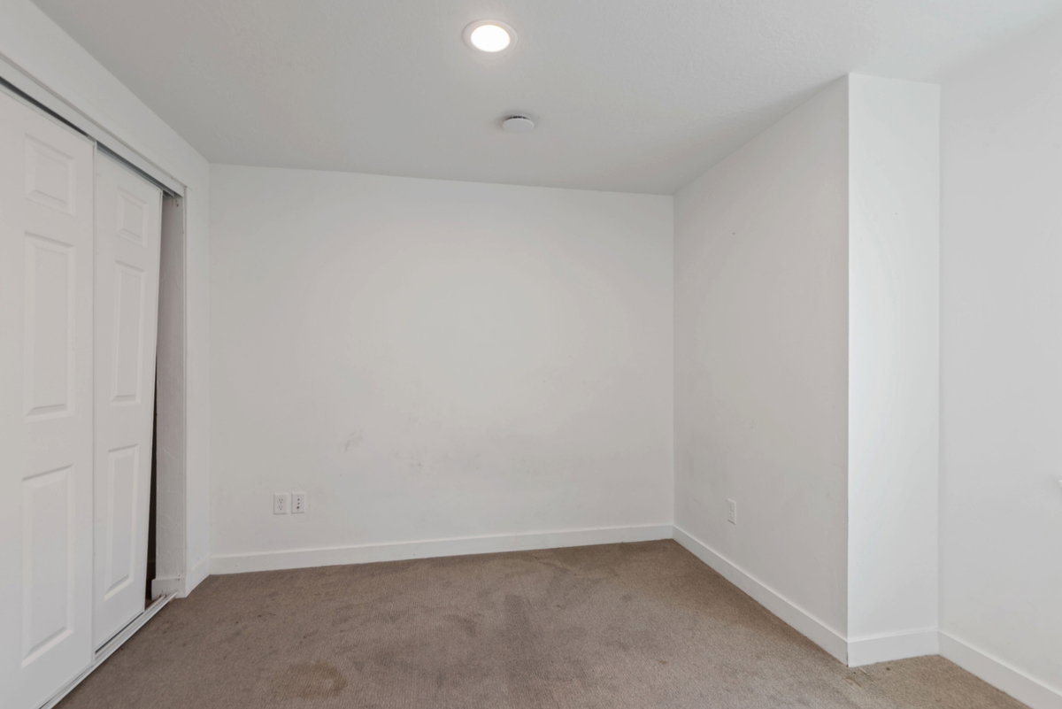 Room featuring carpet flooring, white walls, white baseboards, and a recessed ceiling light