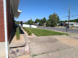 Brick exterior featuring white trim and a concrete driveway