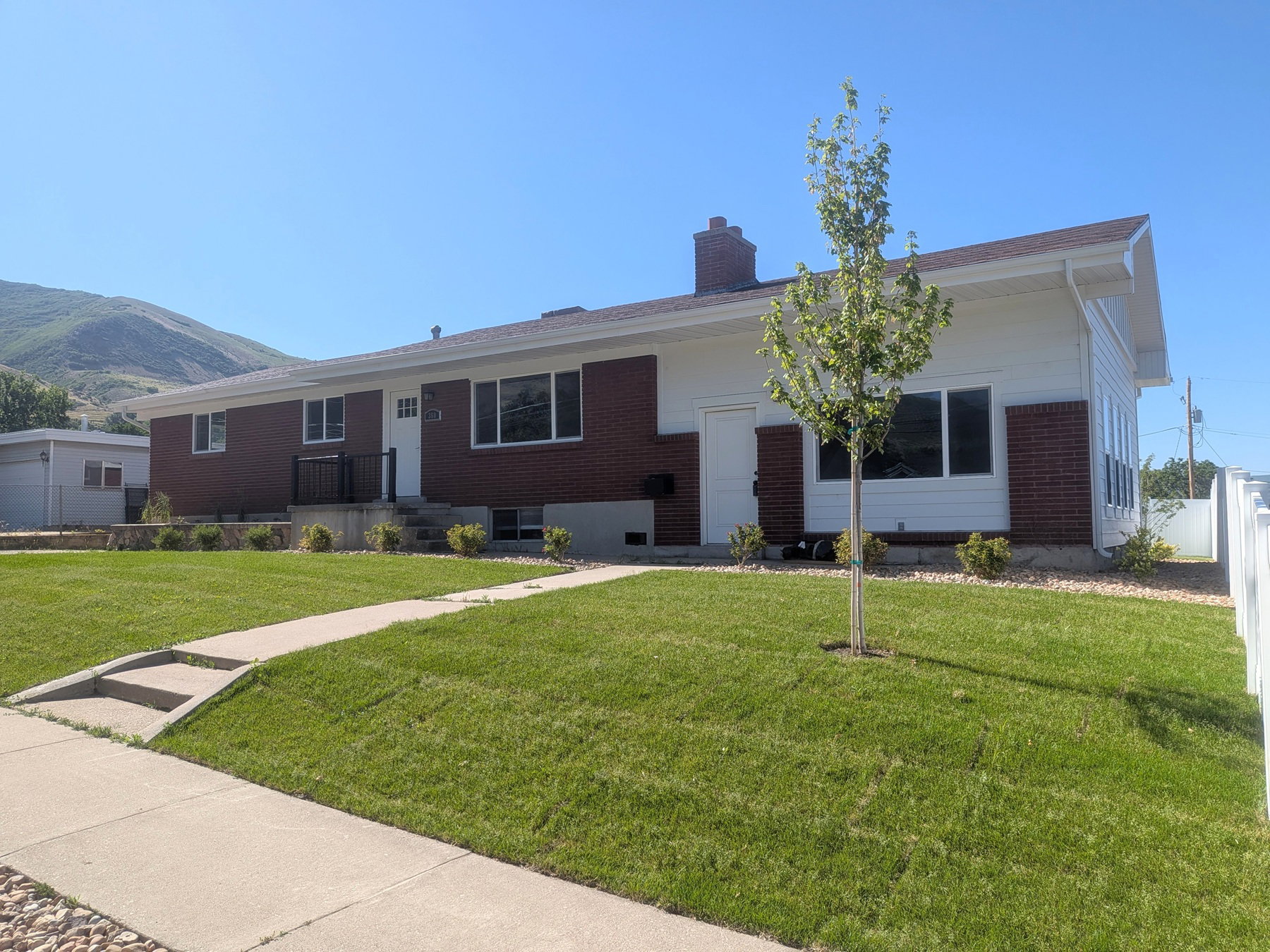 Brick and white siding exterior with a pitched roof