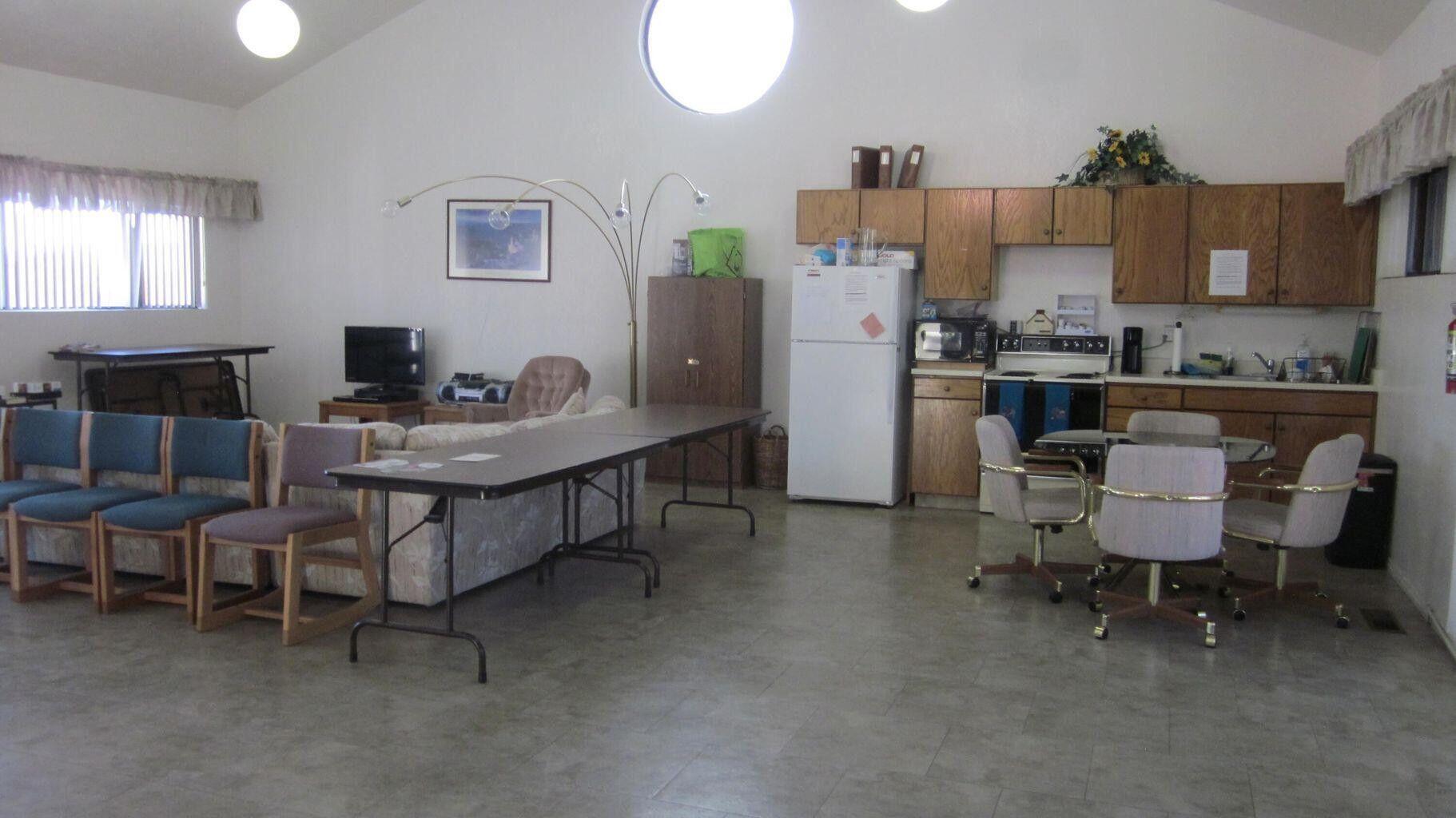 Spacious open-concept room featuring a vaulted ceiling and light-toned flooring