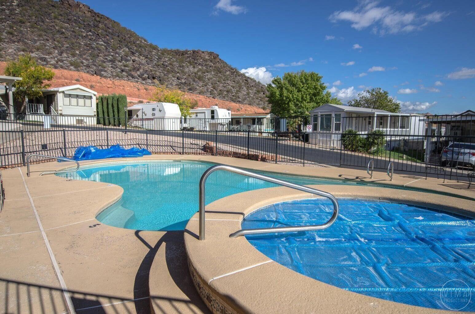 Inviting outdoor pool area featuring a freeform swimming pool and an adjacent circular spa