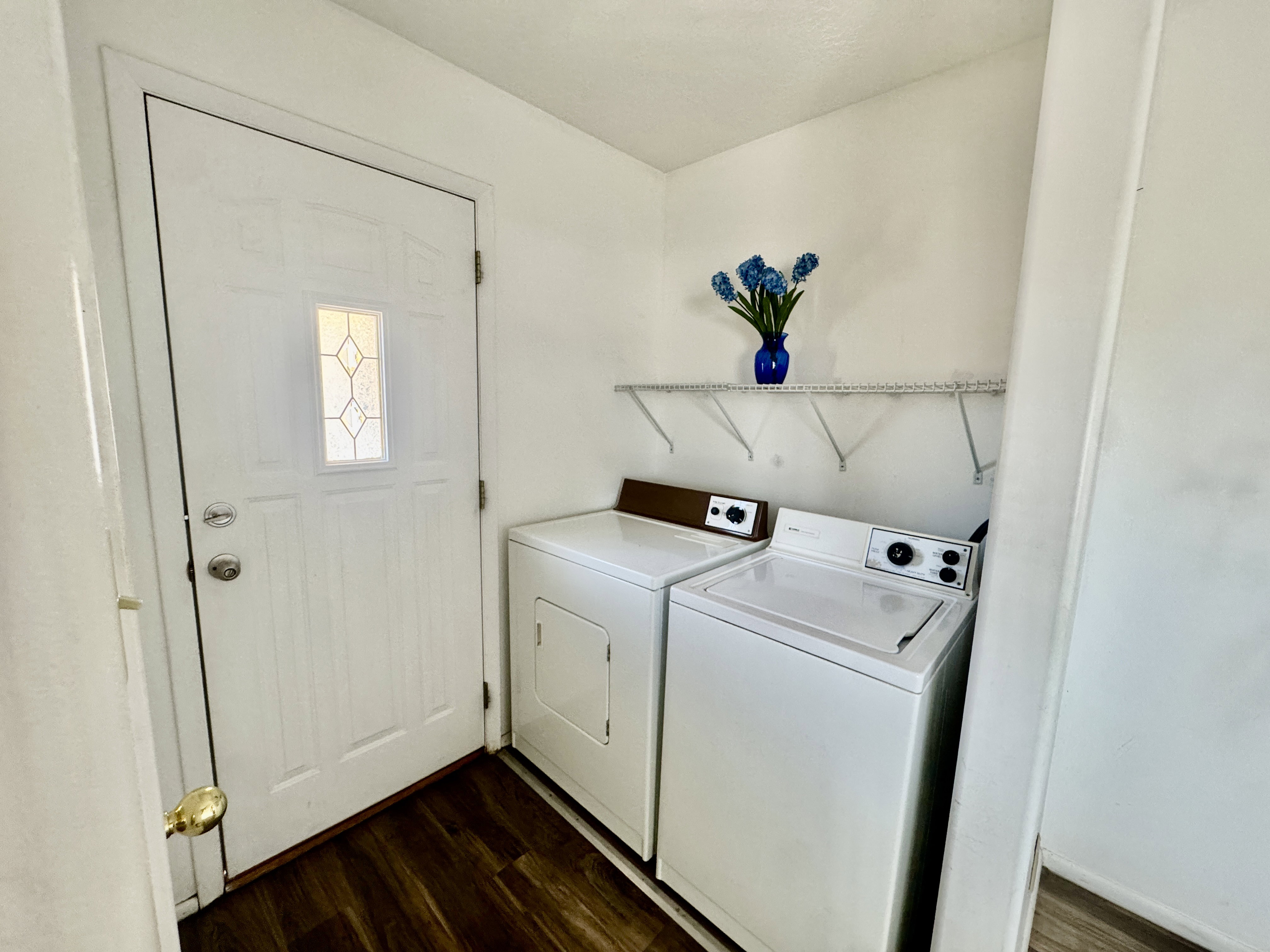 Dedicated laundry area featuring a white top-load washer and front-load dryer