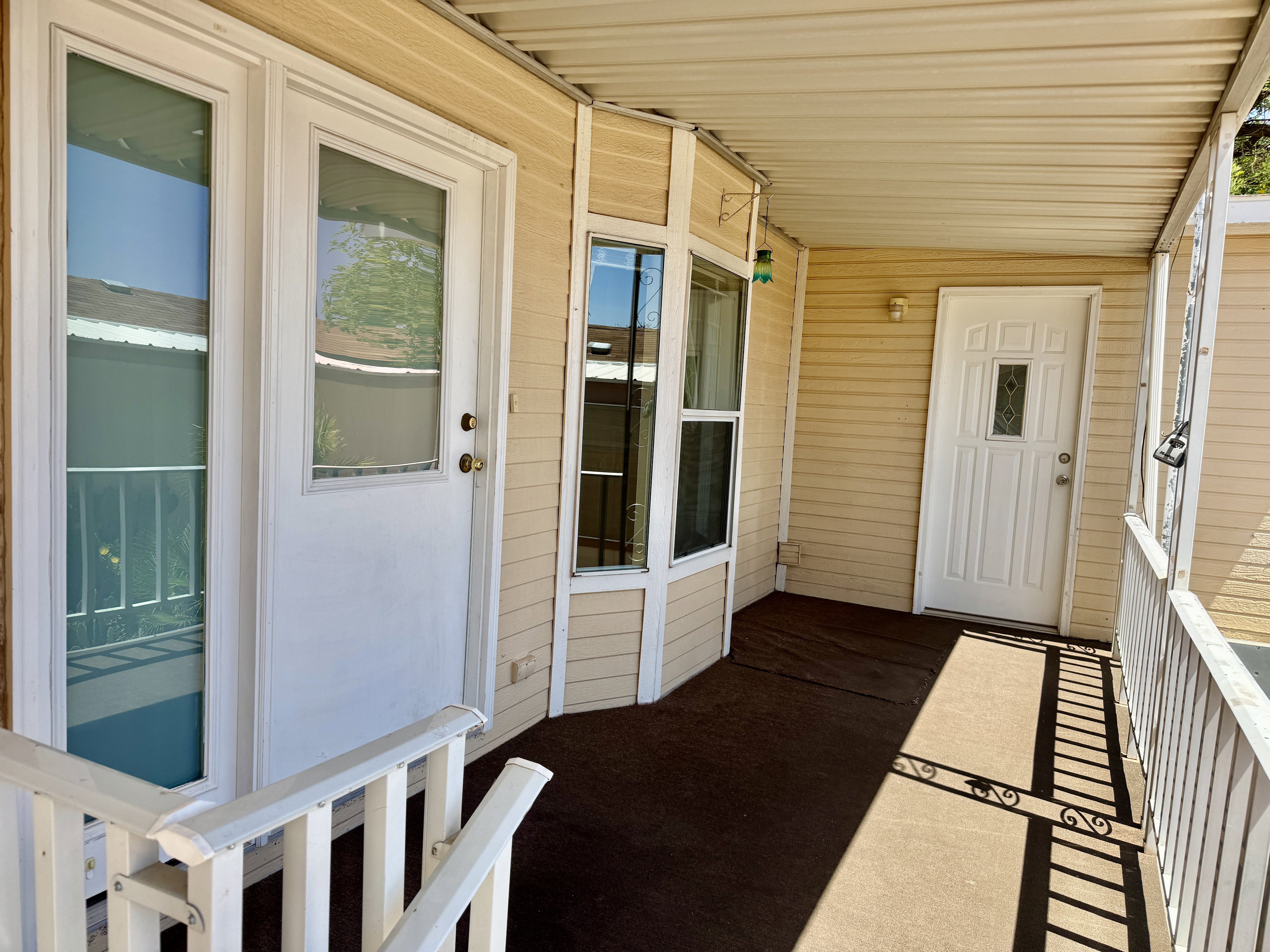 Covered front porch featuring two entry doors