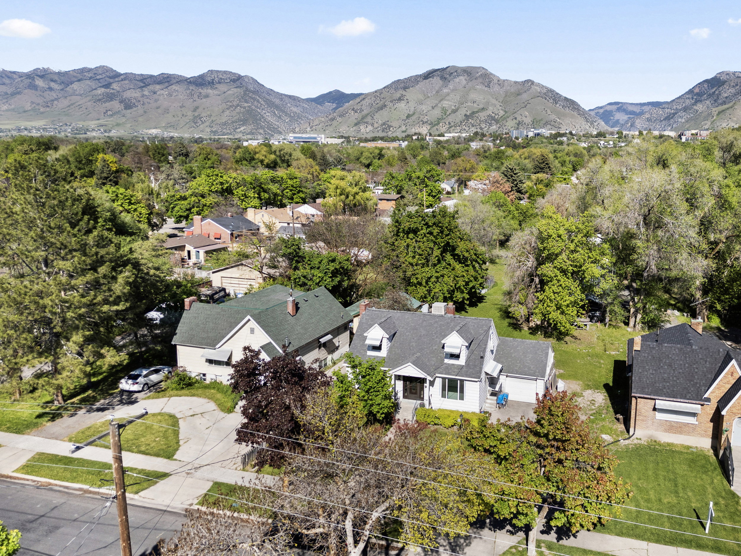Established neighborhood setting with mature trees and mountain backdrop