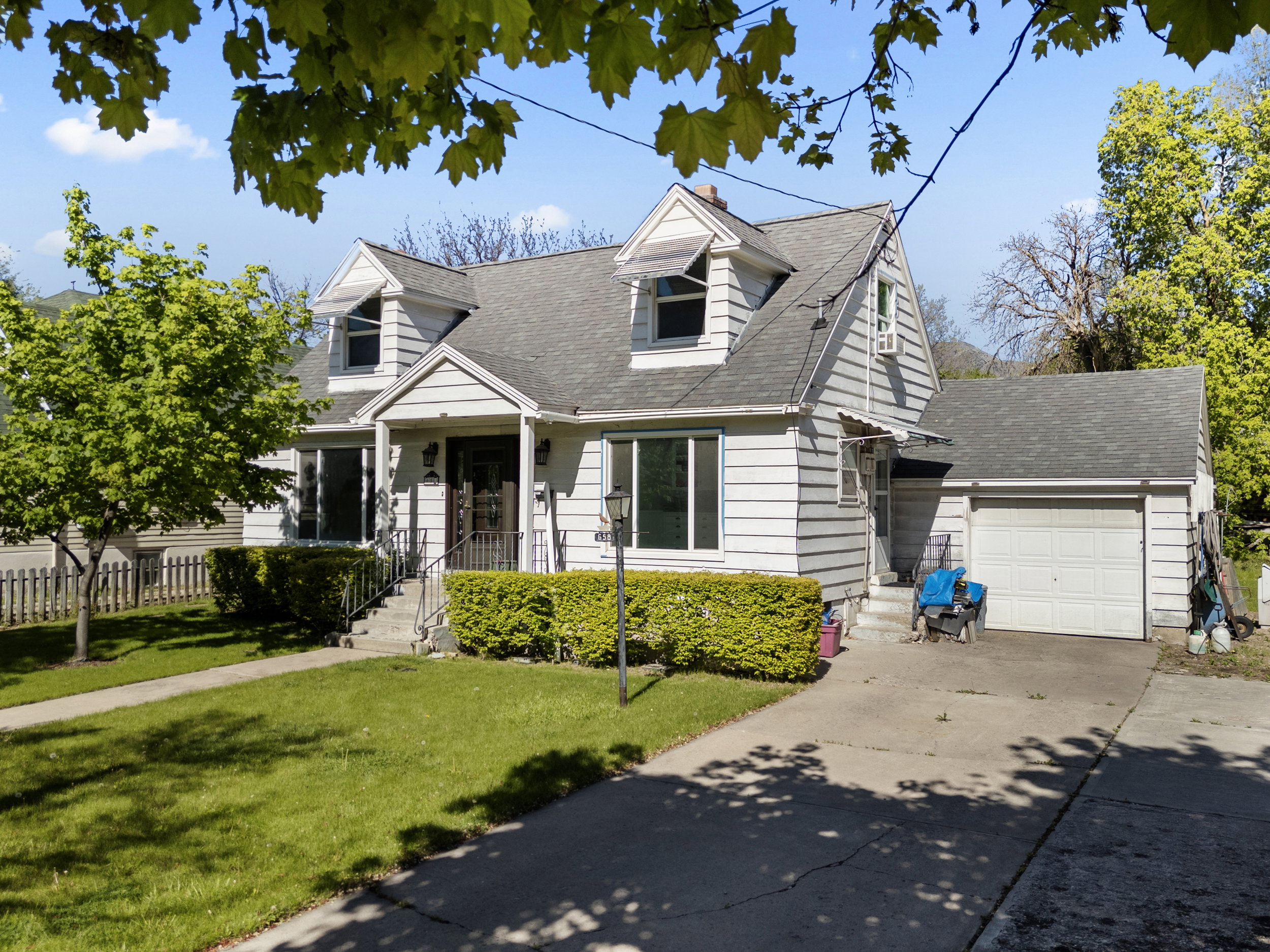 Traditional architecture featuring horizontal siding, a gabled roof, and multiple dormer windows