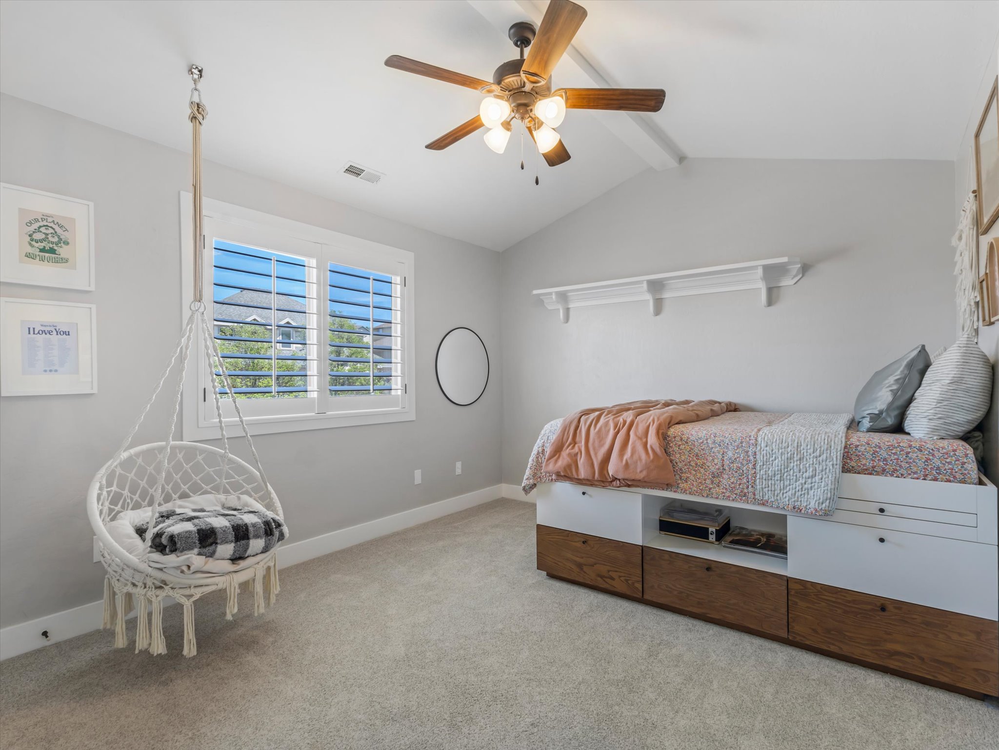 Bedroom featuring a vaulted ceiling with exposed beams, ceiling fan, and carpet flooring