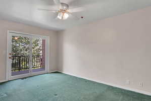 Room with wall-to-wall carpeting and a ceiling fan