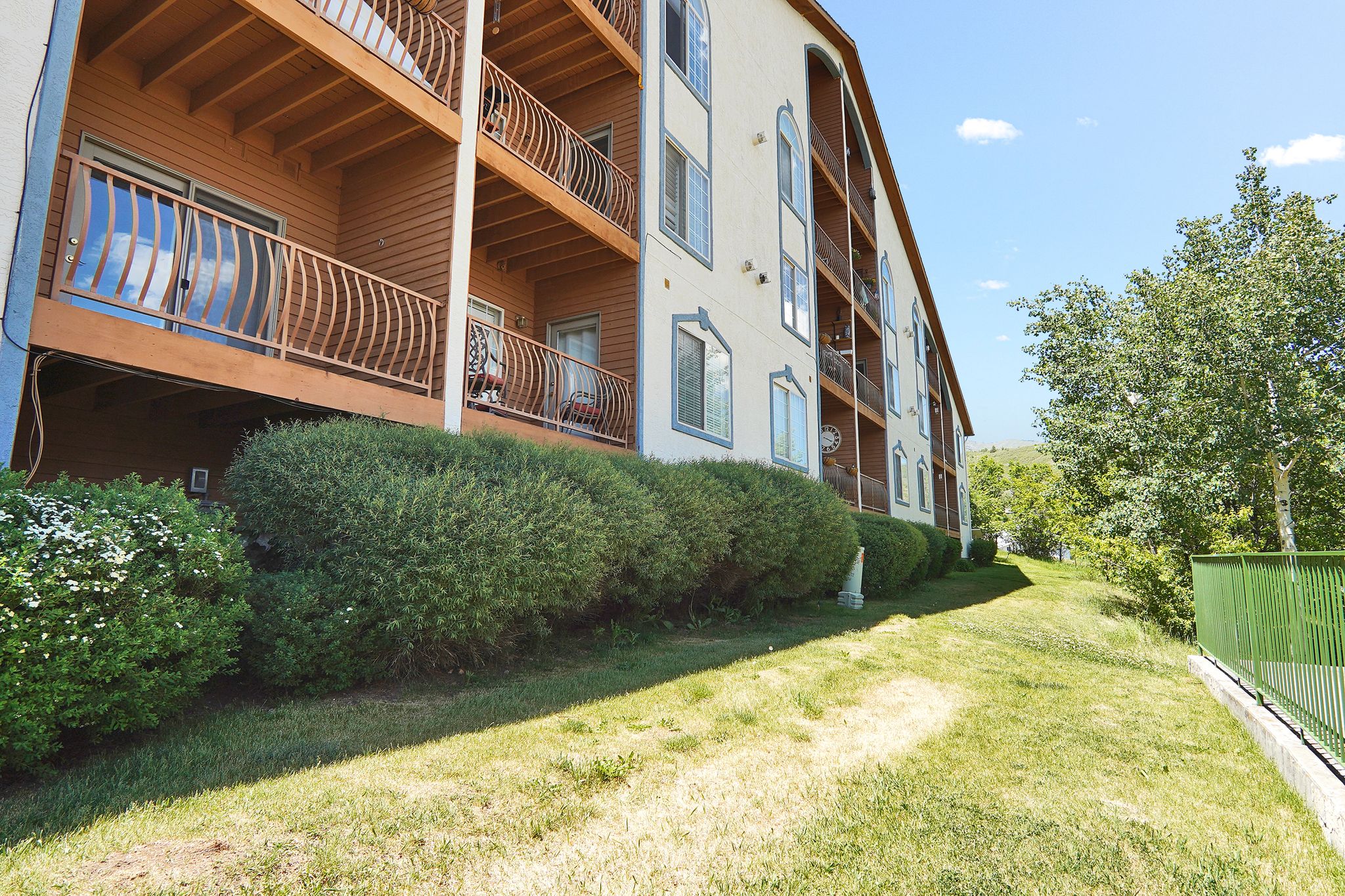 Exterior of rear of building with balconies featuring decorative metal railings