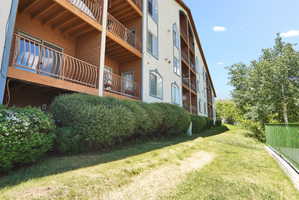Exterior of rear of building with balconies featuring decorative metal railings